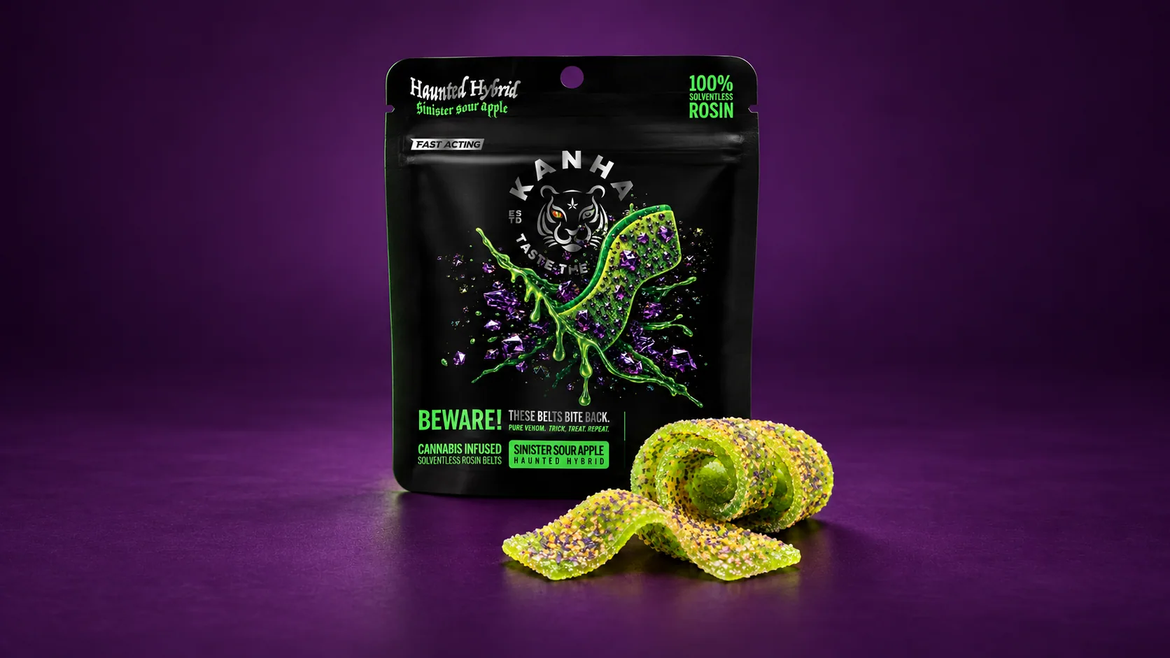 Sinister Sour Apple Crunchy Belts pouch and green crystal-coated belts on a purple background.